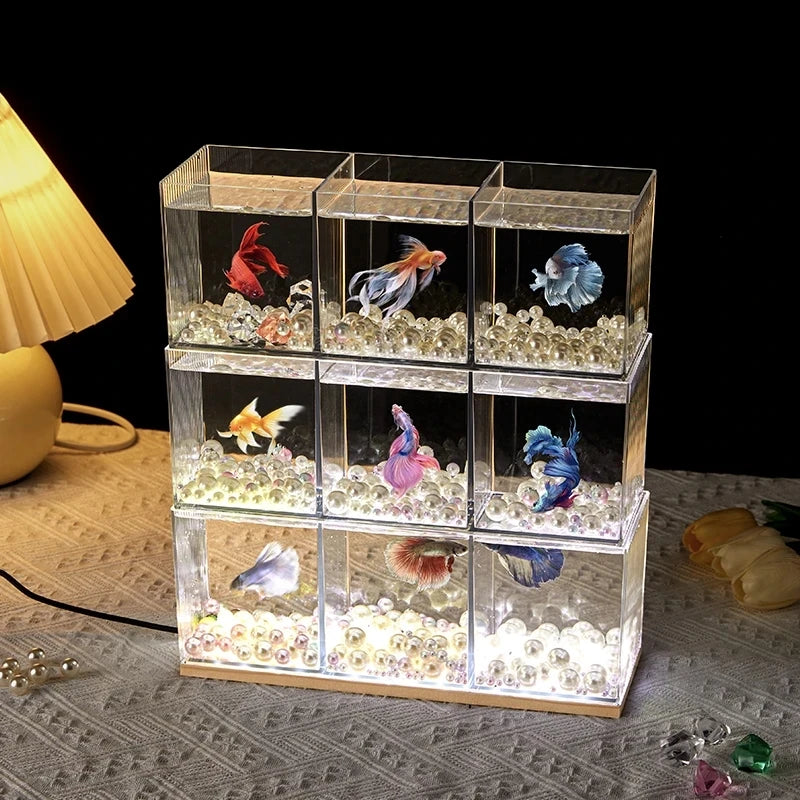 A small barrel-shaped fish tank with a built-in lighting system, a tabletop miniature landscape, and a mini aquarium s