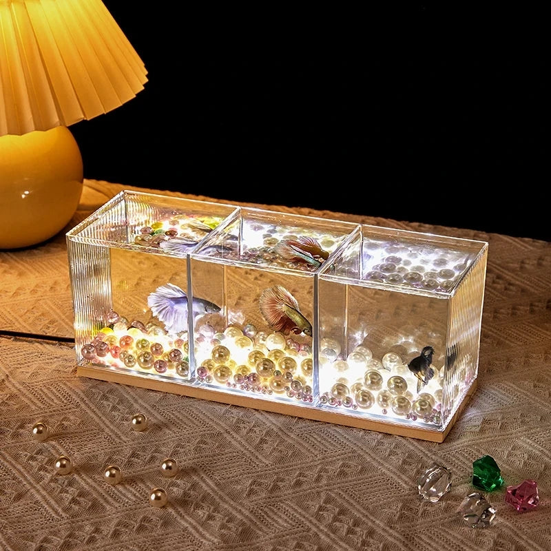 A small barrel-shaped fish tank with a built-in lighting system, a tabletop miniature landscape, and a mini aquarium s