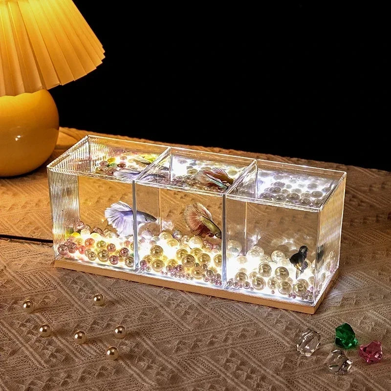 A small barrel-shaped fish tank with a built-in lighting system, a tabletop miniature landscape, and a mini aquarium s