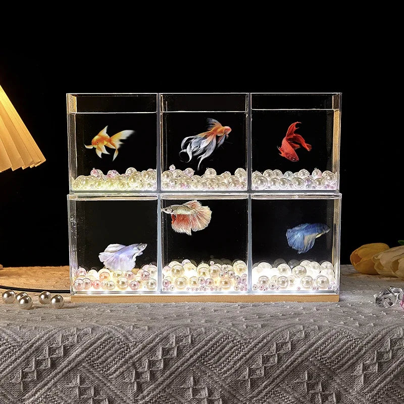 A small barrel-shaped fish tank with a built-in lighting system, a tabletop miniature landscape, and a mini aquarium s
