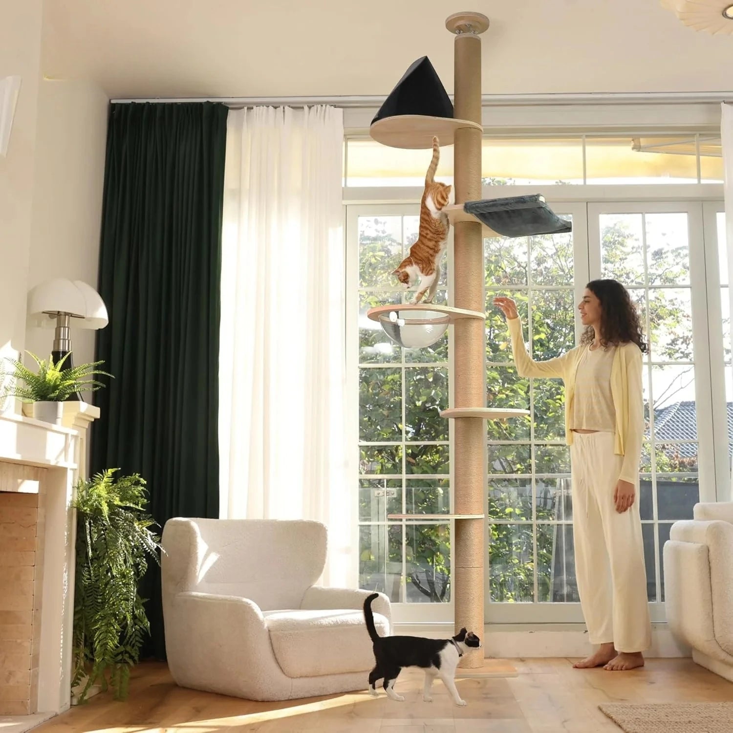 A large, luxurious cat tree made from sustainable wood, featuring climbing posts and toys that extend from floor to ceiling